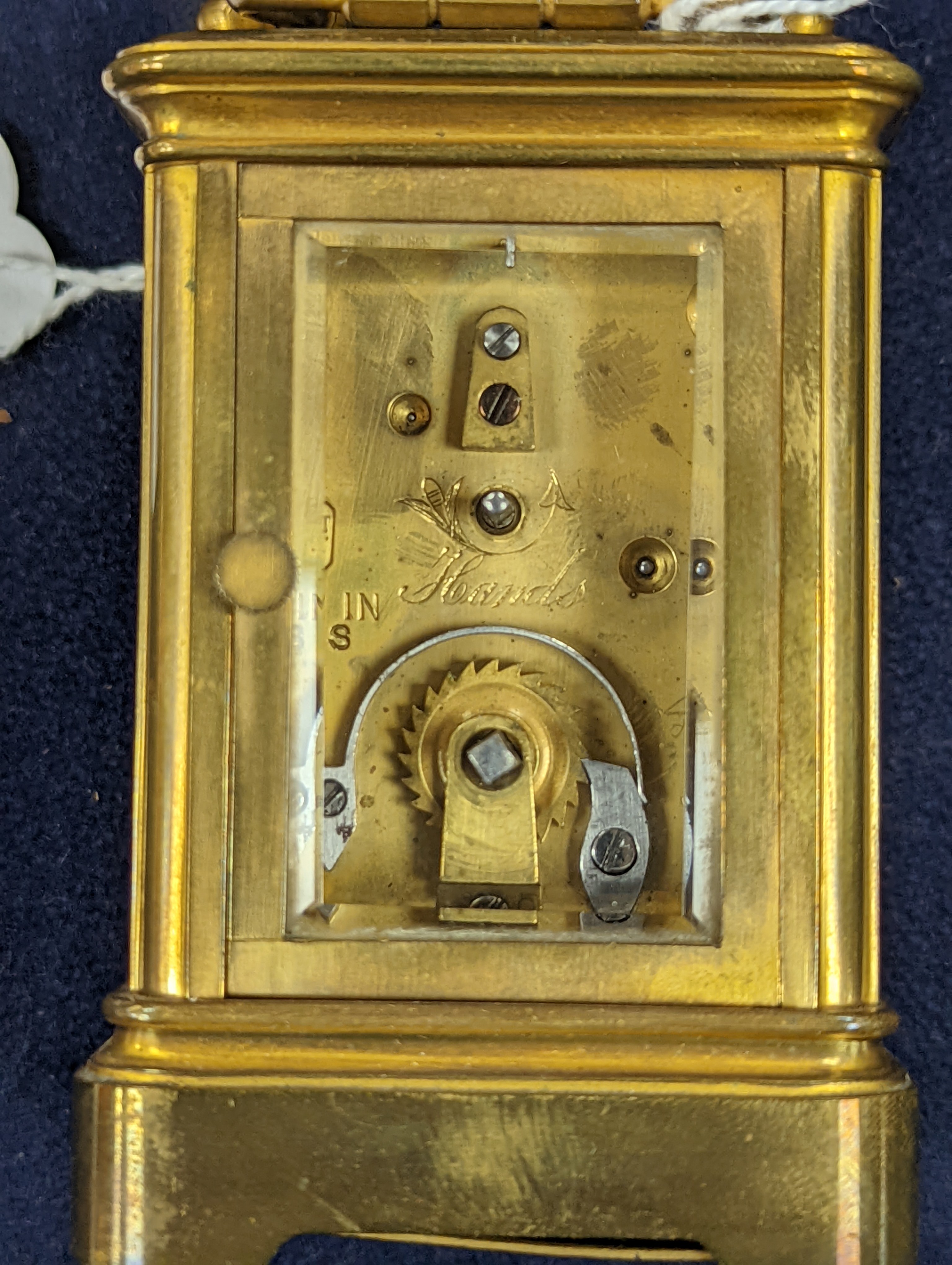 A Henri Jacot brass miniature carriage timepiece, 9.7 cm high with the handle up, cased